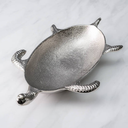 Silver turtle-shaped dish on a light gray background