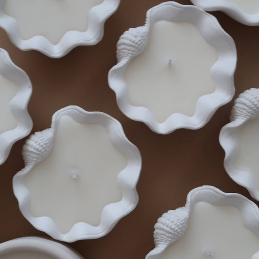 Elevate your ambiance with a Mini Clamshell Candle. Crafted with cruelty-free scents and coconut wax, each candle is meticulously hand-poured to order, ensuring a unique experience for every customer. Each jar is individually hand poured.  

