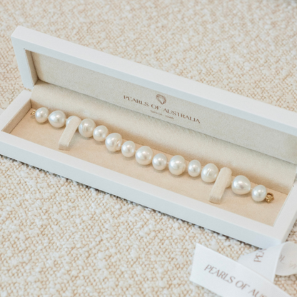 This striking Pearl Strand Bracelet features fifteen (15) Mix 12 to 14mm A2+ to B1+ grade Cygnet Bay (WA) grown Australian South Sea pearls. It is photographed in its iconic Pearls of Australia strand bracelet jewellery box.