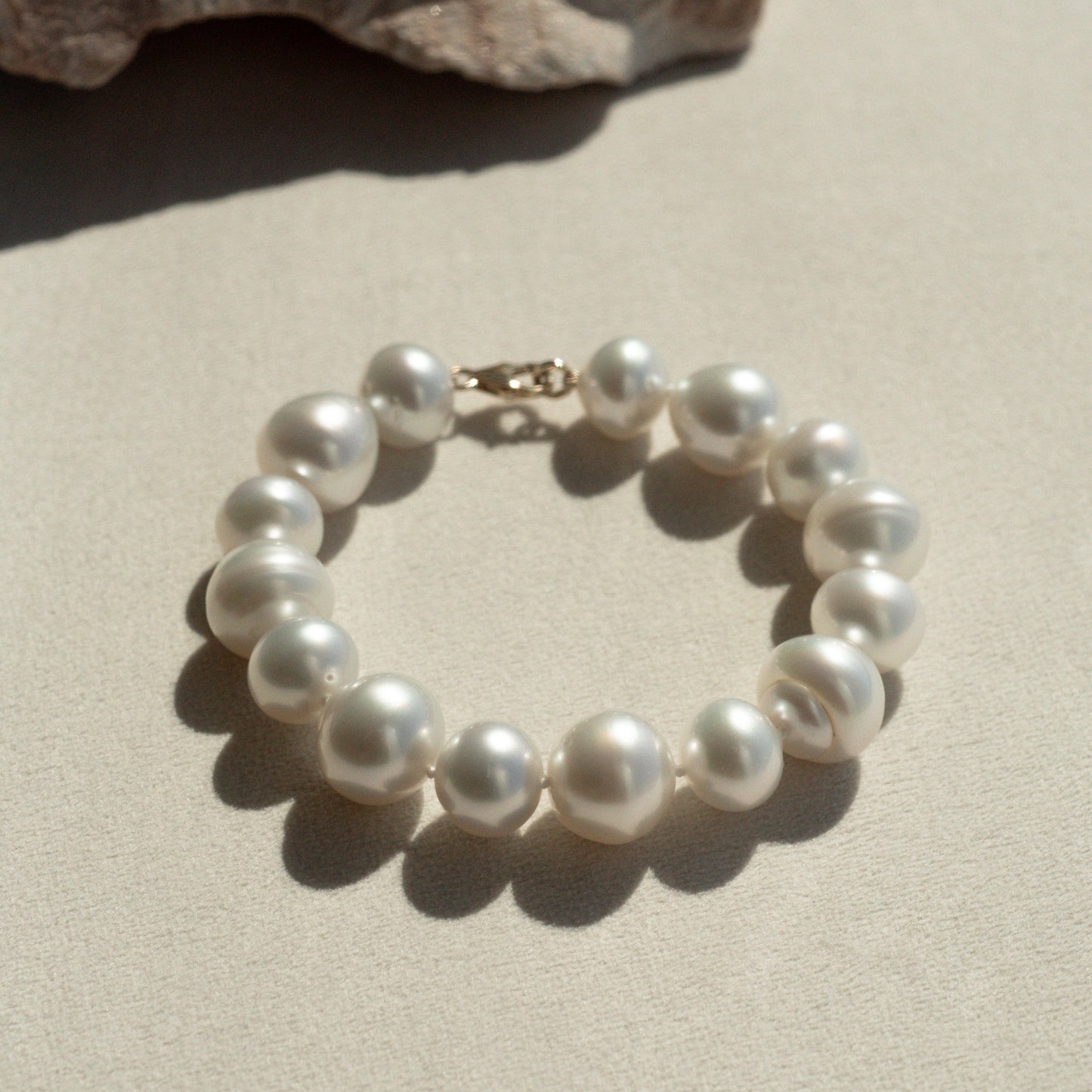 This striking Pearl Strand Bracelet features fifteen (15) Mix 12 to 14mm A2+ to B1+ grade Cygnet Bay (WA) grown Australian South Sea pearls. This 18cm pearl strand is set with an 18ct Yellow Gold clasp.