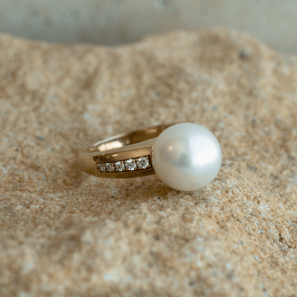 A stunning Mojo Diamond Pearl Ring featuring a Cygnet Bay grown Australian South Sea pearl set alongside a band of diamonds in a gold design.