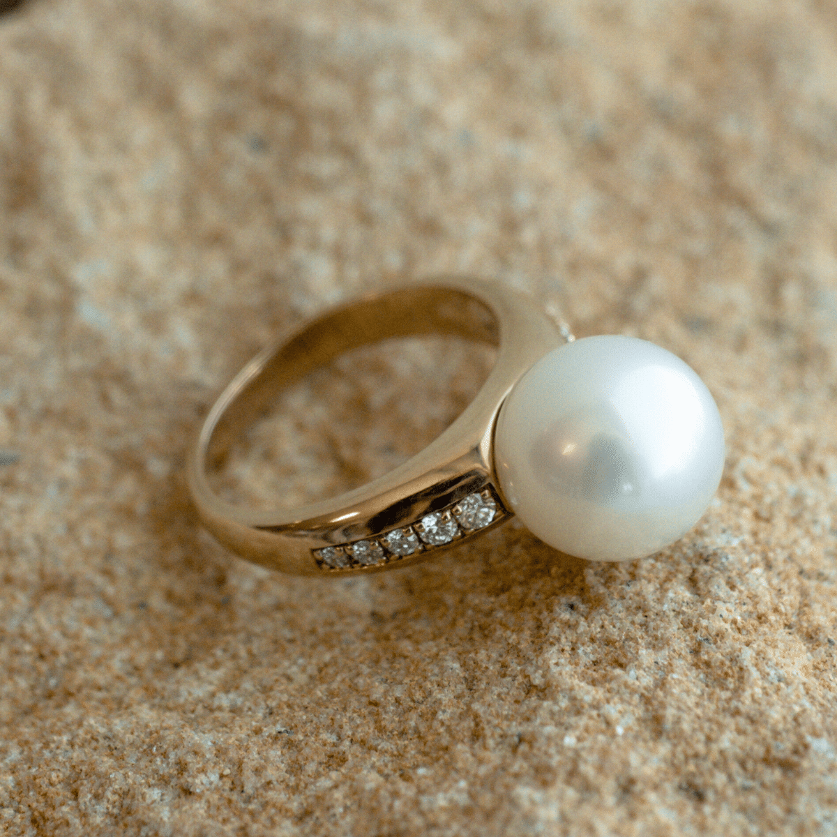 A stunning Mojo Diamond Pearl Ring featuring a Cygnet Bay grown Australian South Sea pearl set alongside a band of diamonds in a gold design.