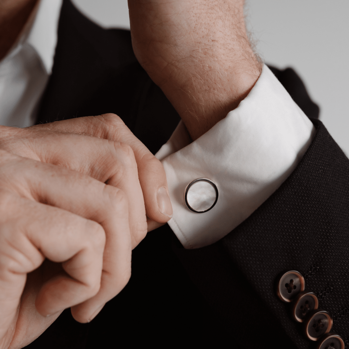 A man wears his timeless My Planet Cufflinks features our Cygnet Bay (WA) Australian South Sea Mother of Pearl shell set in Sterling Silver.