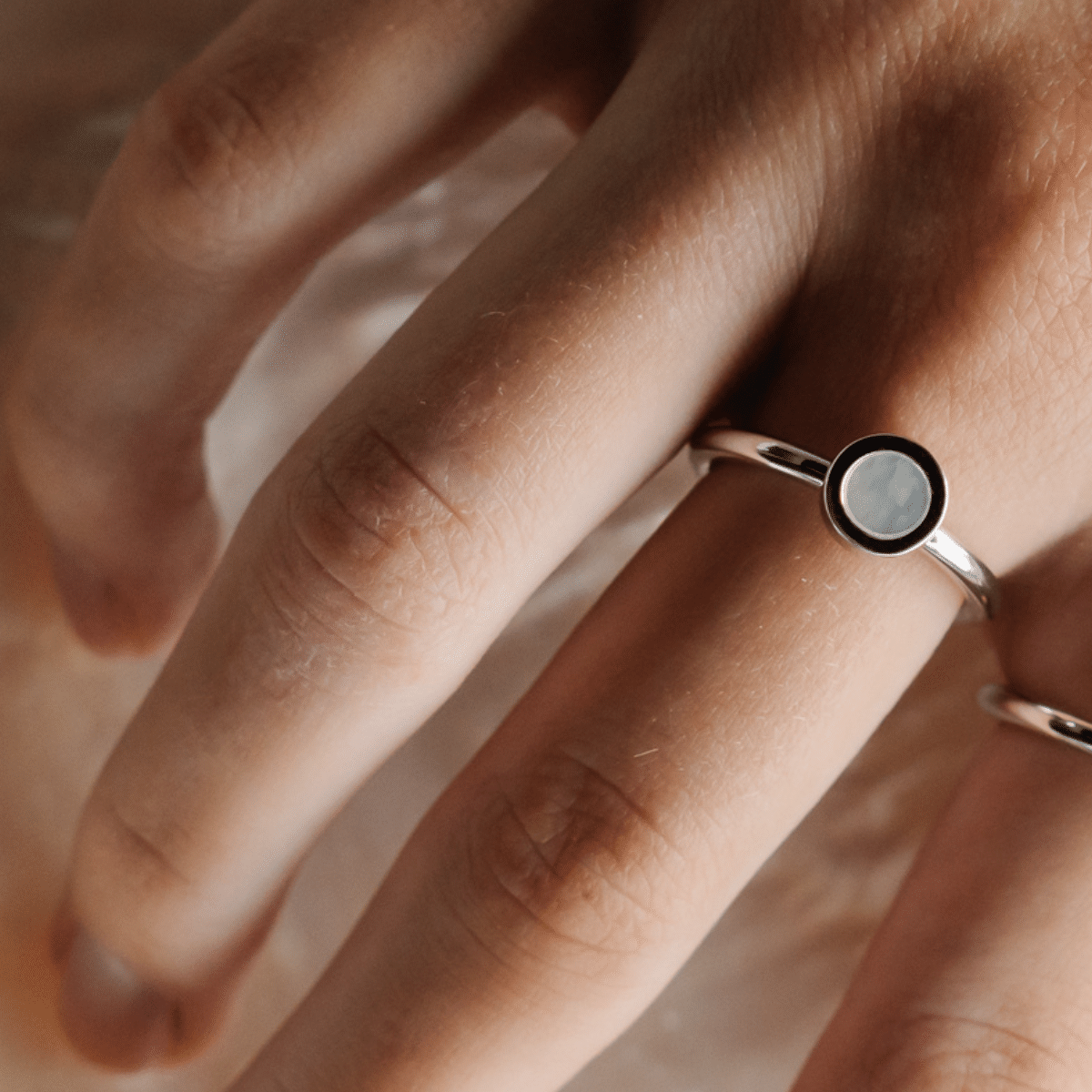 A woman wears her timeless My Planet Petite Ring features our Cygnet Bay (WA) Australian South Sea Mother of Pearl shell set in Sterling Silver.