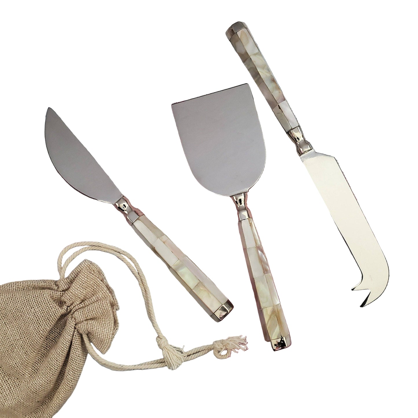 Set of three metal cheese tools with decorative handles on a checkered cloth background