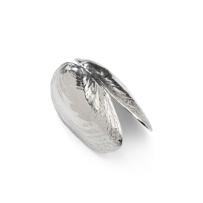 Mussel shovel sitting on a white surface