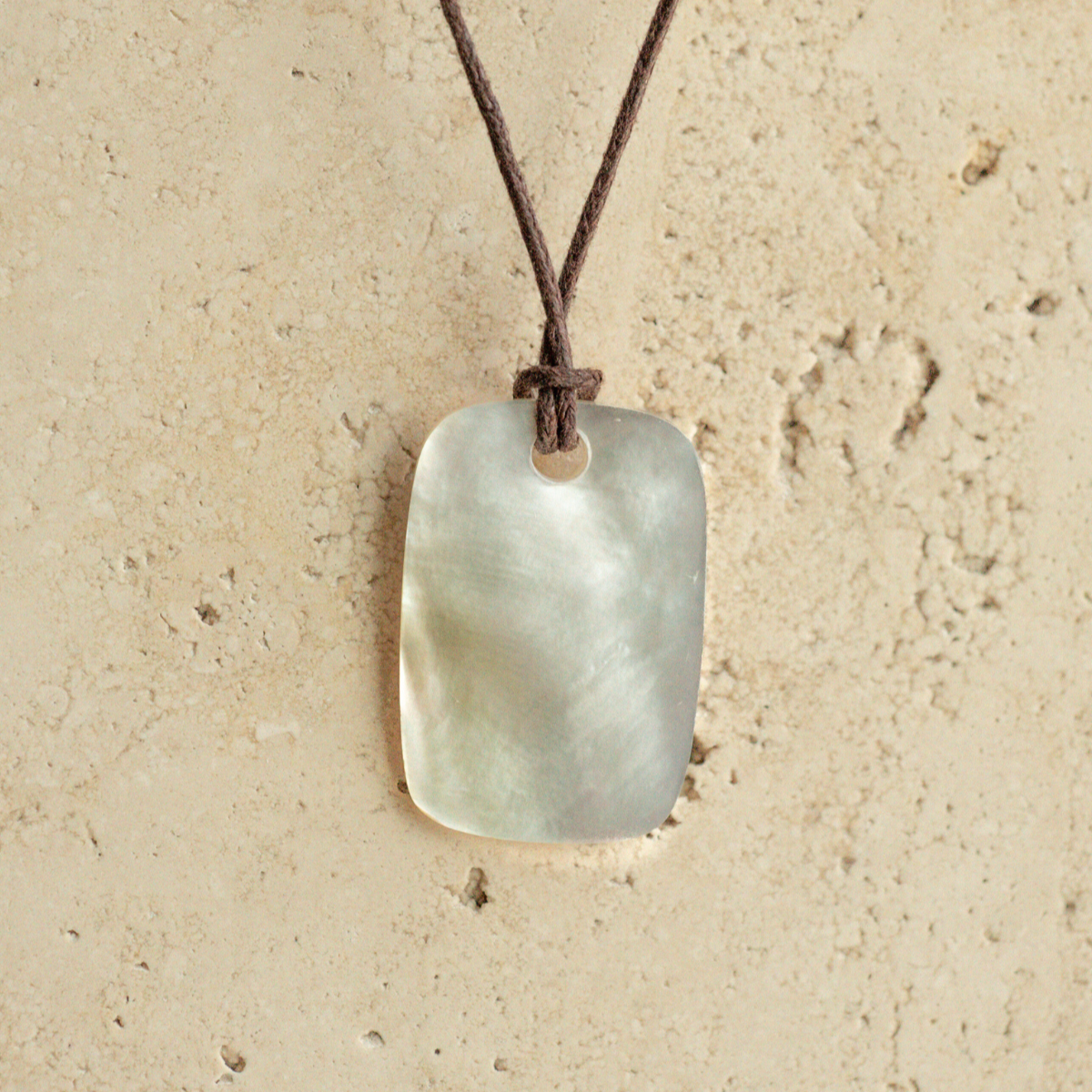 Our stunning Mother of Pearl Nacre Necklace features our Cygnet Bay grown Mother of Pearl shell carved into a rectangle shape, strung on a leather cord.