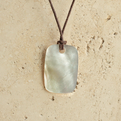 Our stunning Mother of Pearl Nacre Necklace features our Cygnet Bay grown Mother of Pearl shell carved into a rectangle shape, strung on a leather cord.