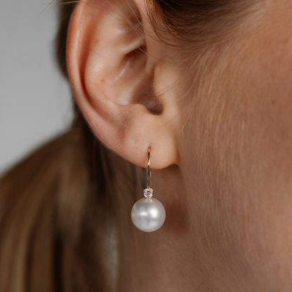 A woman wears her Nivea Pearl Hooks feature a pair of Cygnet Bay (NSW) grown Australian South Sea Pearls with two White set in gold.