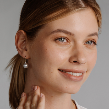 A woman wears her Nivea Pearl Hooks feature a pair of Cygnet Bay (NSW) grown Australian South Sea Pearls with two White set in gold.