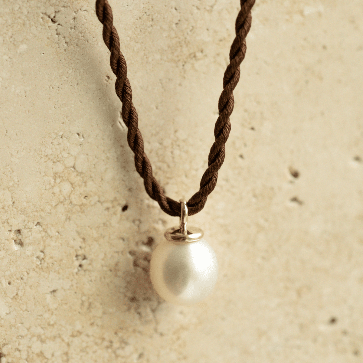 A classic Pearl Charm Silk Necklace featuring a Cygnet Bay (WA) grown Australian South Sea pearl set on a 100% silk cord rope.