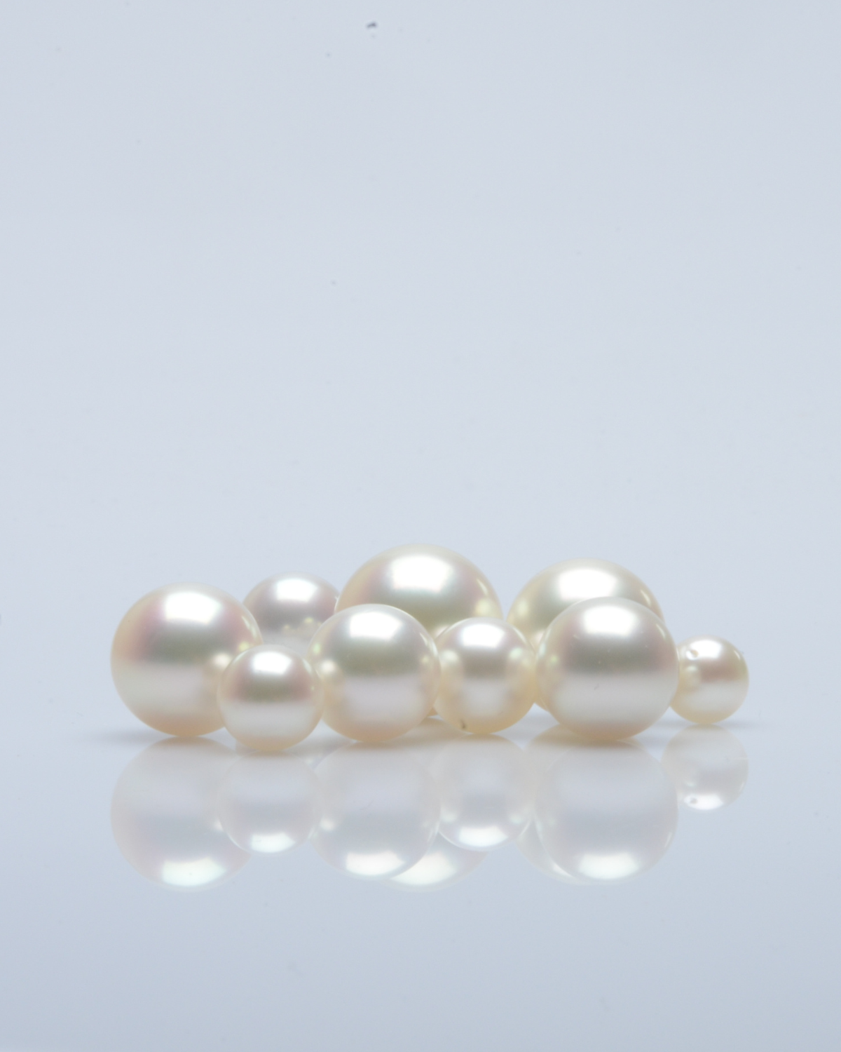 Set of loose pearls on a light gray background