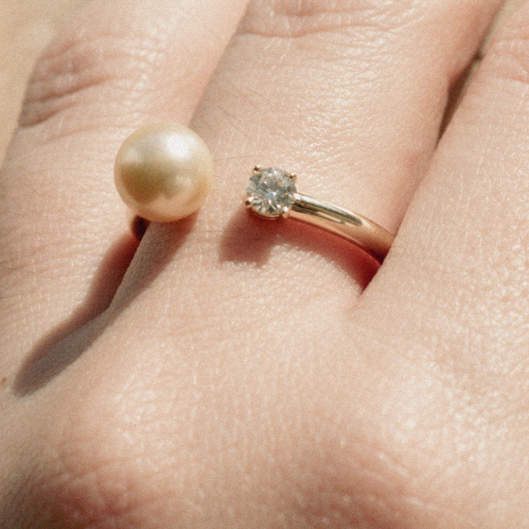 A woman wears her Provenance Open Diamond Pearl Ring features a Cygnet Bay (WA) grown Australian South Sea pearl and a stunning White Diamond set on a gold band.