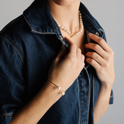 This stunning Radiance Emerald Cut &amp; Pearl Bangle features faceted Mother of Pearl grown at our Cygnet Bay Pearl Farm (WA) alongside a Cygnet Bay (WA) grown 10.5mm Drop A3 grade Australian South Sea pearl set in sterling silver and gold.&nbsp;