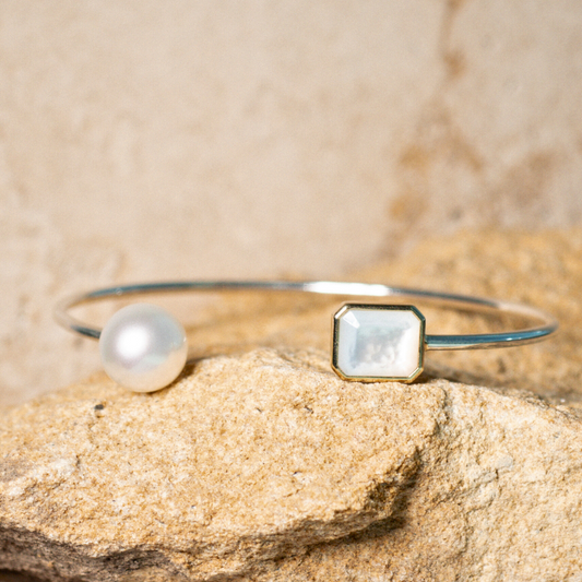 This stunning Radiance Emerald Cut &amp; Pearl Bangle features faceted Mother of Pearl grown at our Cygnet Bay Pearl Farm (WA) alongside a Cygnet Bay (WA) grown Australian South Sea pearl.