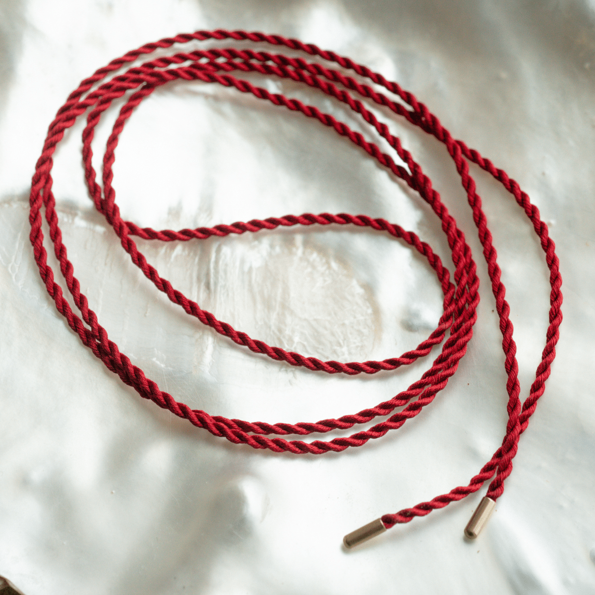 A versatile 100% Japanese Red Silk Cord Rope with stainless steel end caps, measuring at 100cm long.