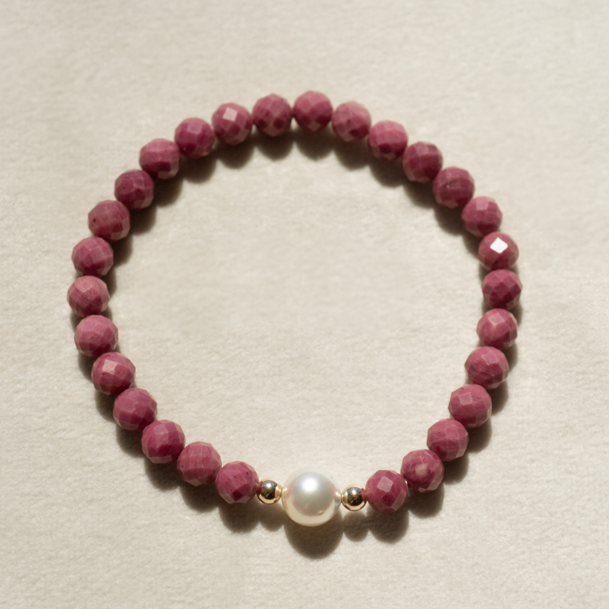 Featuring a luminous Cygnet Bay (WA) grown 8.5mm Round B1 grade Australian South Sea pearl nestled alongside 28 faceted rhodonite beads and two 9ct yellow gold rondels