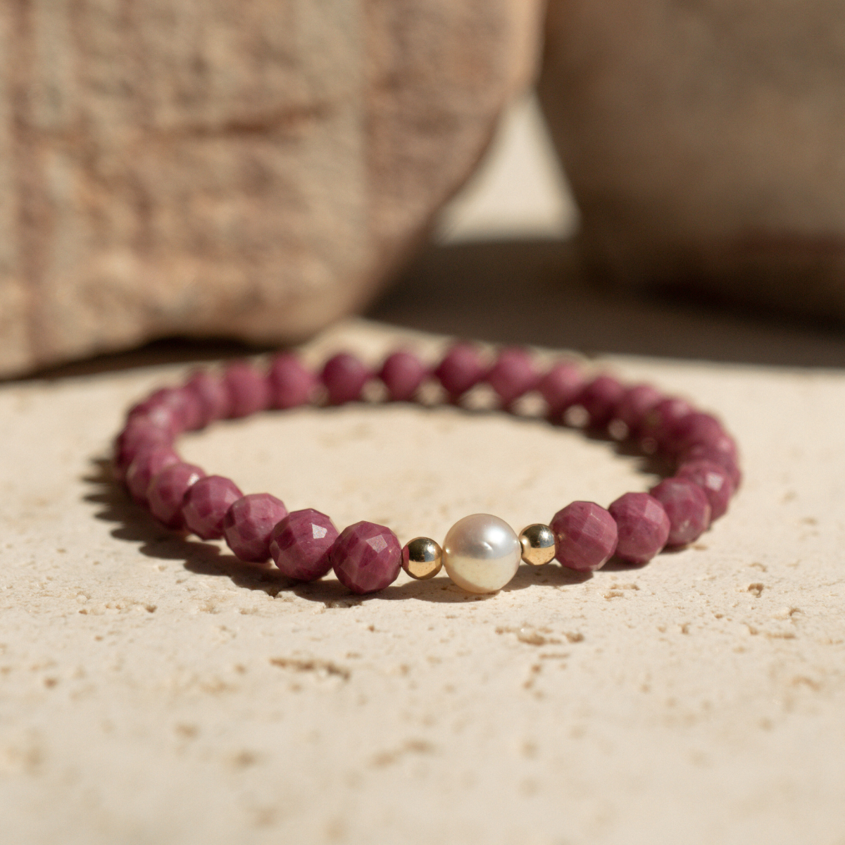 Featuring a luminous Broken Bay (NSW) grown 7mm AAA grade Australian Akoya pearl nestled alongside 28 faceted rhodonite beads and two 9ct yellow gold rondels