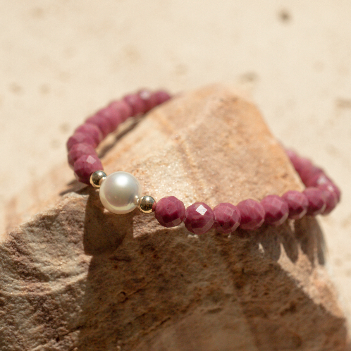 Featuring a luminous Cygnet Bay (WA) grown 8.5mm Round B1 grade Australian South Sea pearl nestled alongside 28 faceted rhodonite beads and two 9ct yellow gold rondels