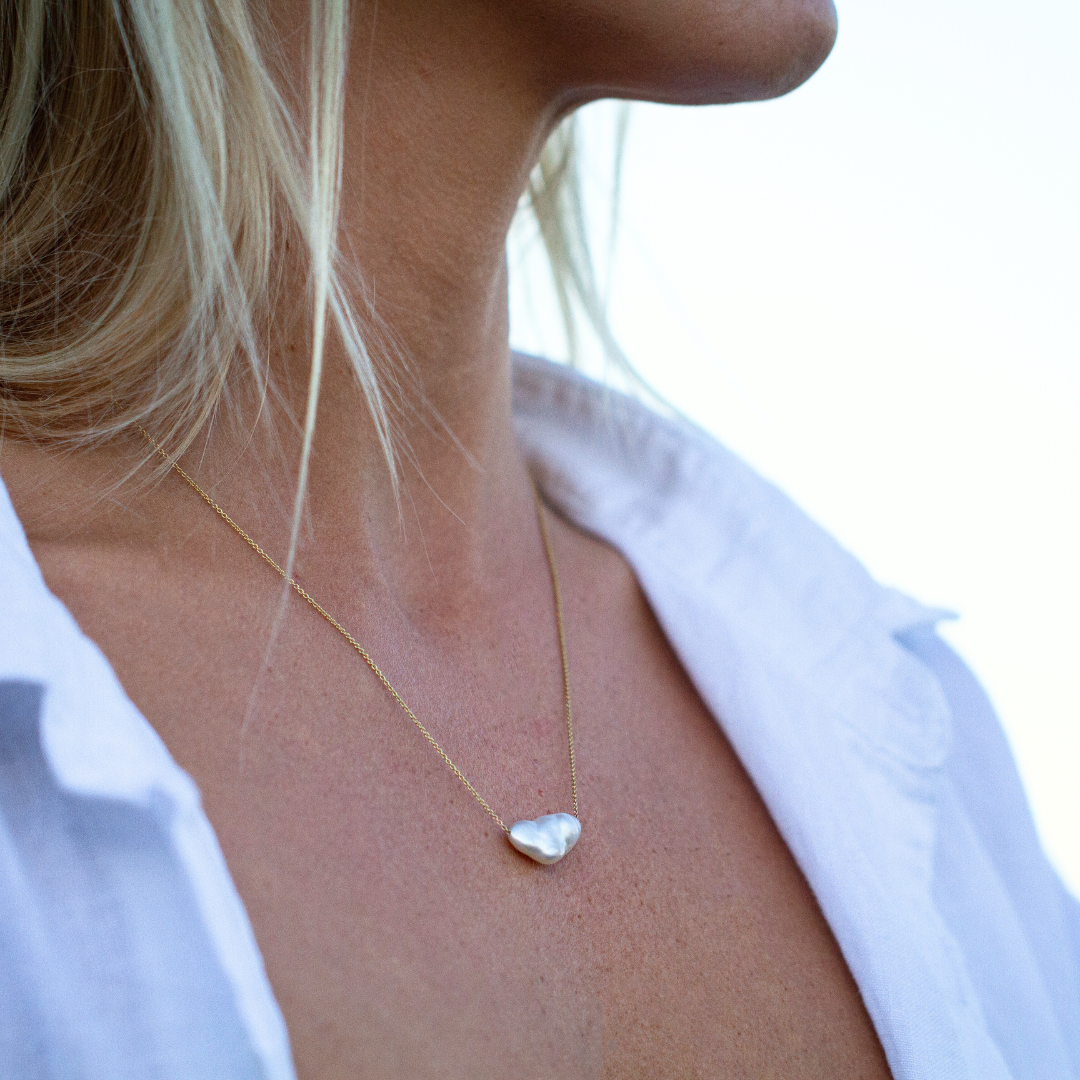 A woman wears her Savanna Pearl Necklace featuring a Cygnet Bay (WA) grown Australian South Sea Keshi Pearl set on a gold chain.