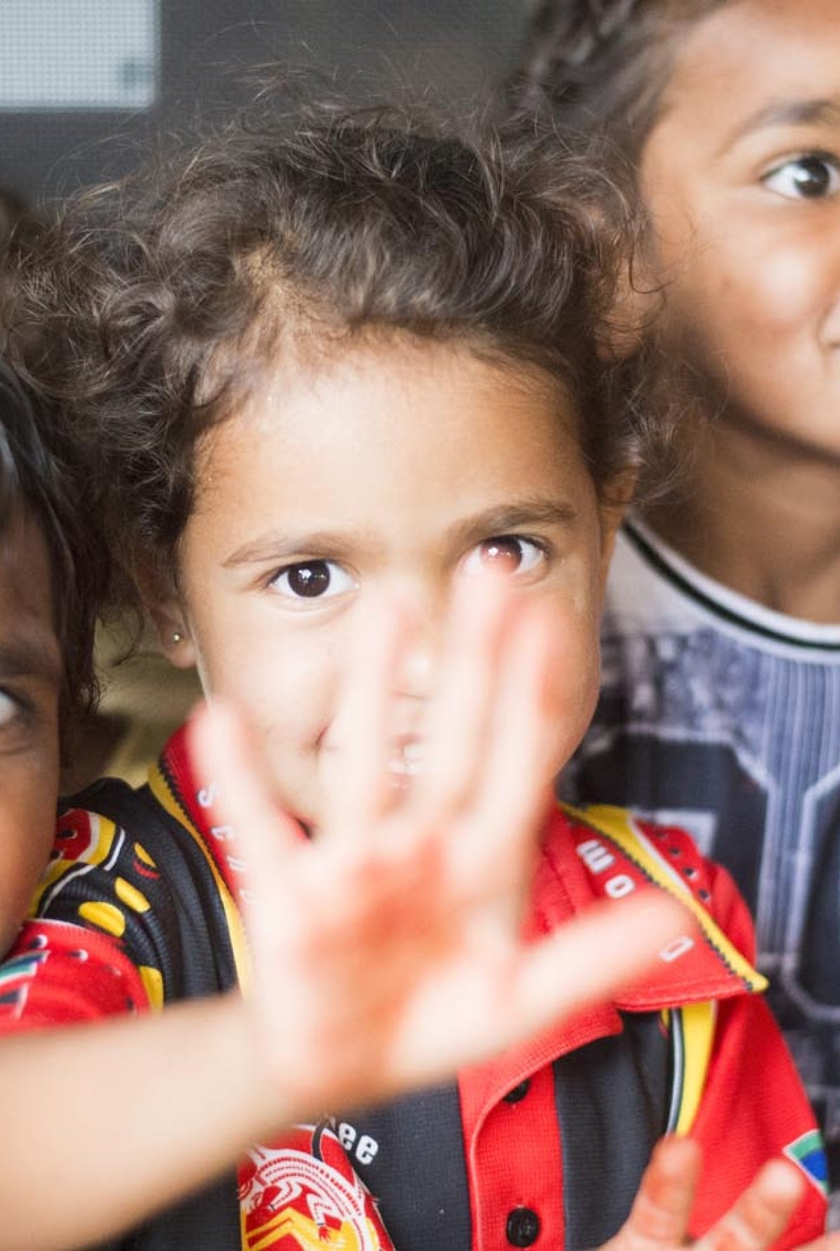 A child waves at the camera