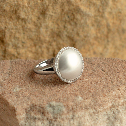 This gorgeous Save the Children Halo Diamond Pearl Ring features a Cygnet Bay (WA) grown Australian South Sea Mabe pearl alongside a halo of White Diamonds set in gold.