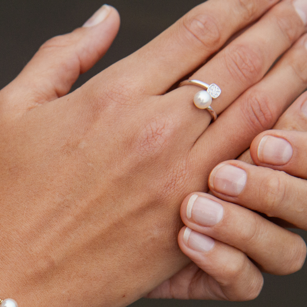 A person wears their elegant Seagrass Pearl Ring featuring a Broken Bay (NSW) grown Australian Akoya pearl set in gold.