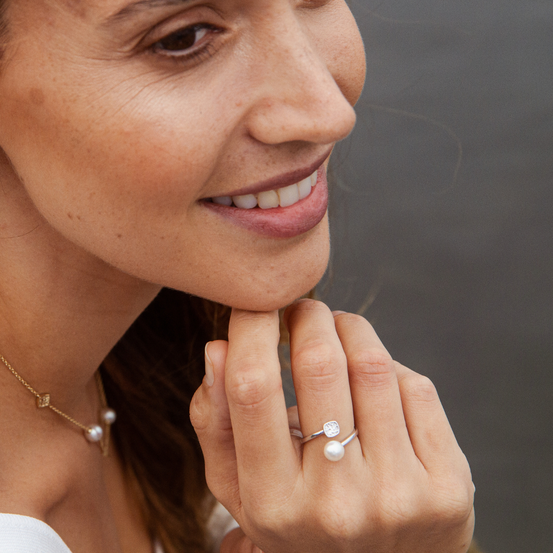 A woman wears her elegant Seagrass Pearl Ring featuring a Broken Bay (NSW) grown Australian Akoya pearl set in gold.