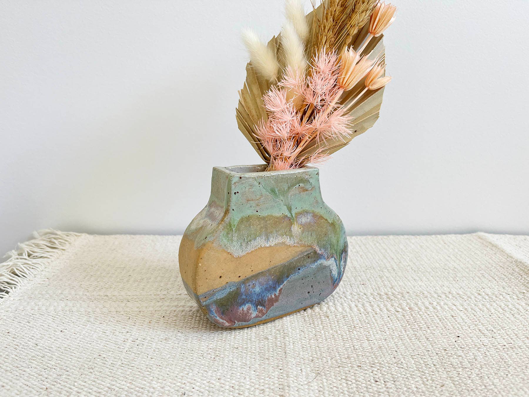 The colour palette of the vase is reminiscent of the ocean's depths, featuring shades of blues and greens. These hues evoke a sense of tranquility, while hints of white and sandy tones add a touch of coastal elegance.


