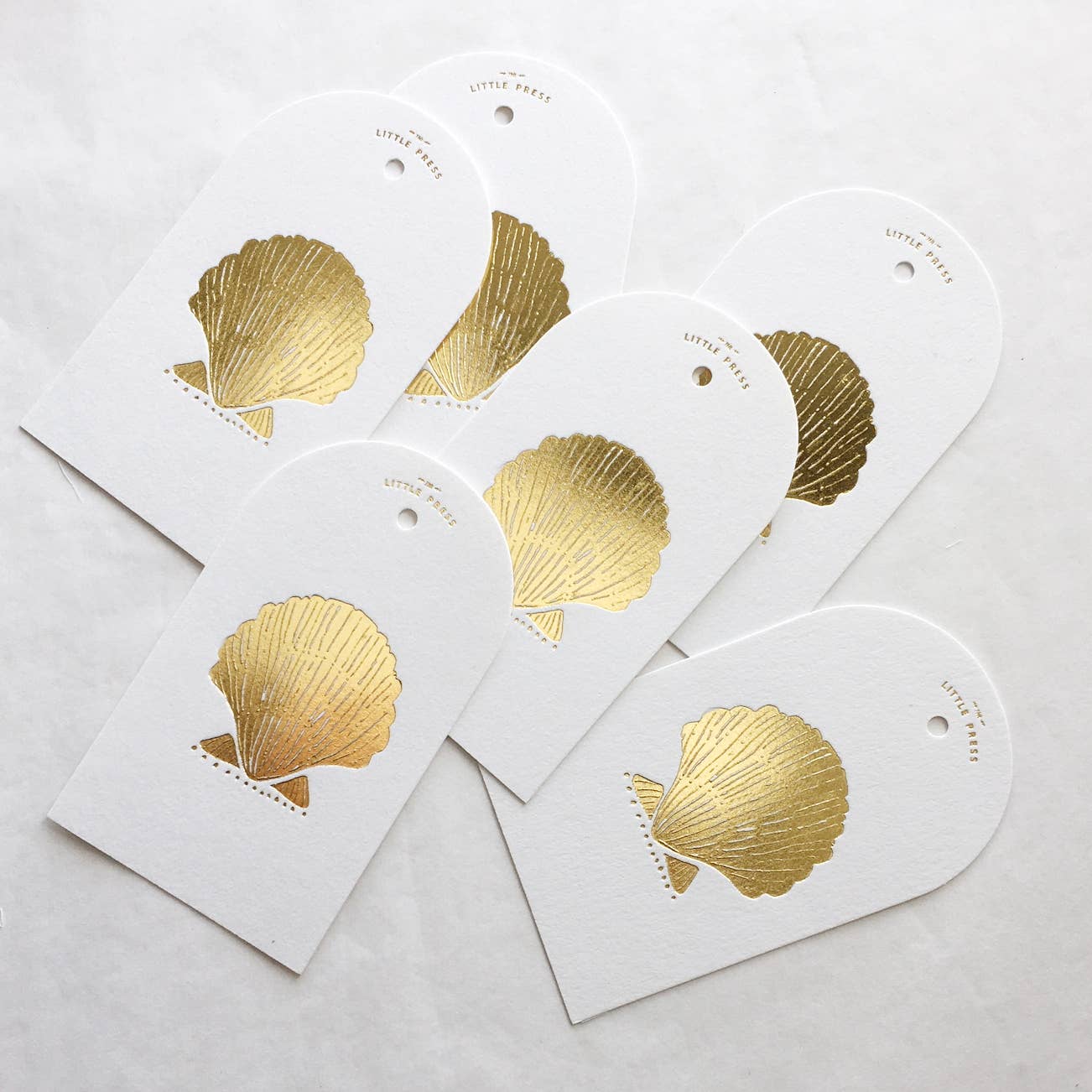 Luxury tags for gifting and decorating, in a die-cut arch shape with hole punch.

