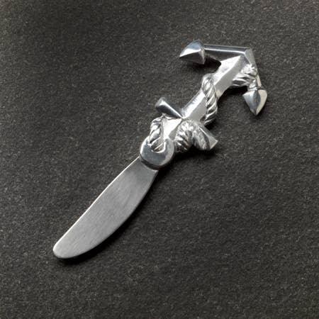 Silver decorative knife with a unique design on a dark background
