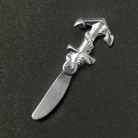 Metallic knife-shaped bottle opener on a dark background