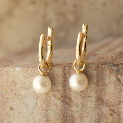 These Simple Pearl Huggie Earrings feature a pair of Broken Bay (NSW) grown 6.5mm AA grade (moderately blemished) Australian Akoya pearls set in  gold plated sterling silver.