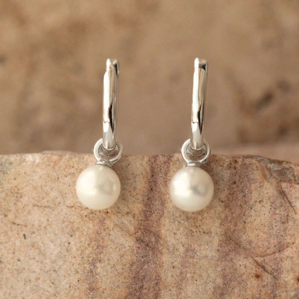 These Simple Pearl Huggie Earrings feature a pair of Broken Bay (NSW) grown 6.5mm AA grade (moderately blemished) Australian Akoya pearls set in sterling silver.