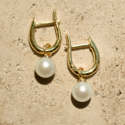 These Simple Pearl Huggie Earrings feature a pair of Broken Bay (NSW) grown 6.5mm AA grade (moderately blemished) Australian Akoya pearls set in  gold plated sterling silver.