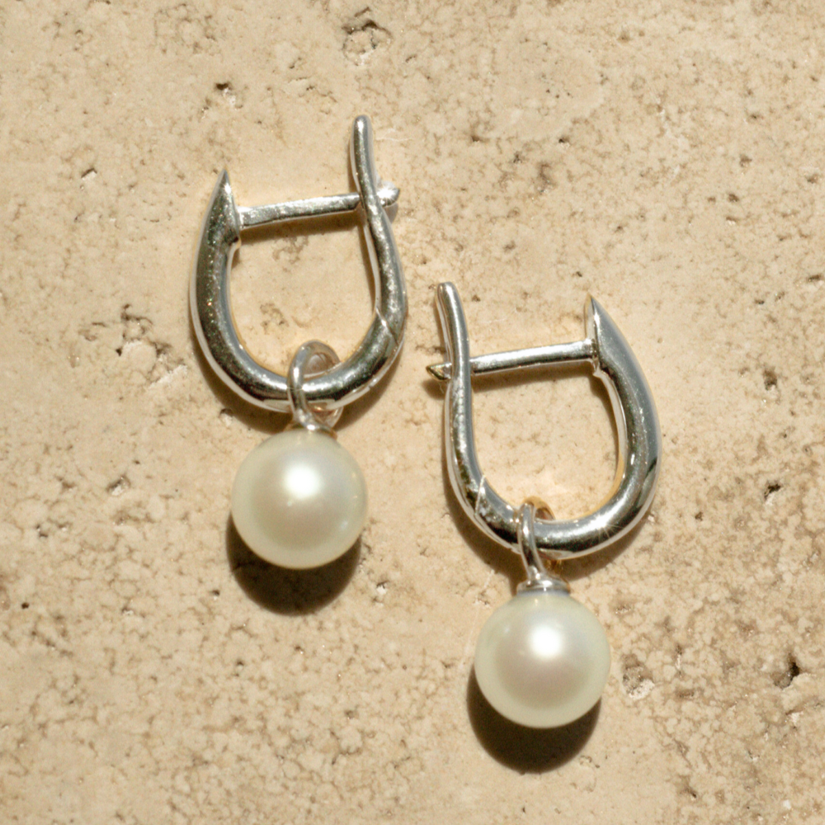 These Simple Pearl Huggie Earrings feature a pair of Broken Bay (NSW) grown 6.5mm AA grade (moderately blemished) Australian Akoya pearls set in sterling silver.