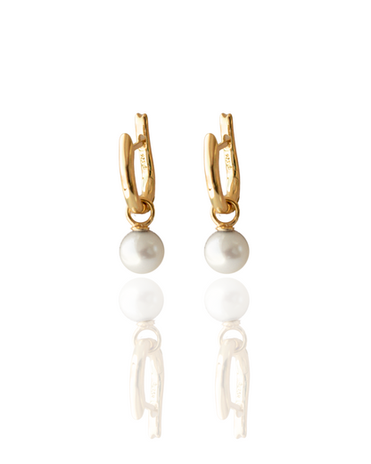 These Simple Pearl Huggie Earrings feature a pair of Broken Bay (NSW) grown 6.5mm AA grade (moderately blemished) Australian Akoya pearls set in  gold plated sterling silver.