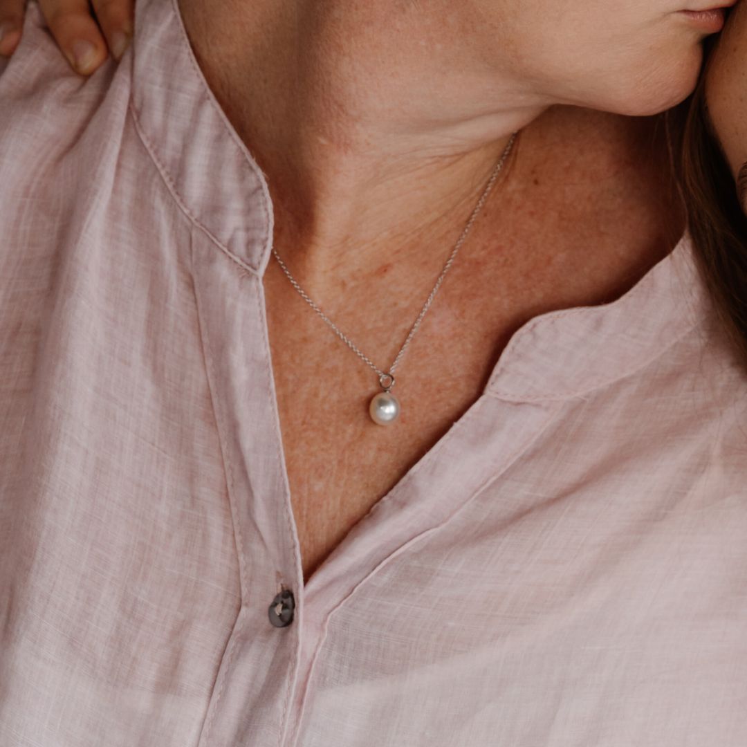 A woman wears her Australian South Sea Charm Pendant set in white gold. 