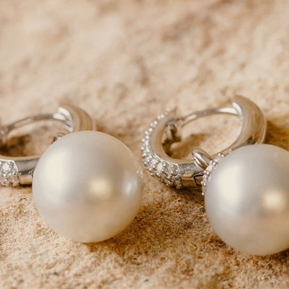 A stunning pair of Stella Pearl Huggie Earrings featuring Cygnet Bay (WA) grown Australian South Sea pearls complemented by 96 White Diamonds set in gold.