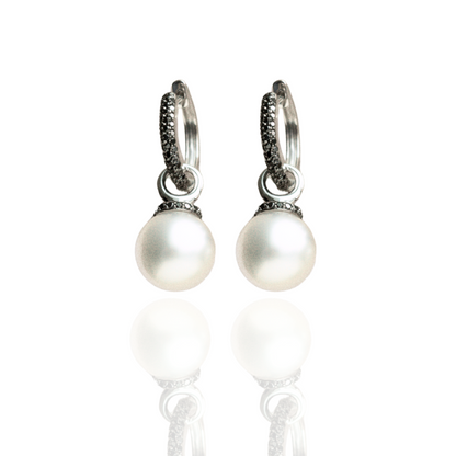 A pair of stunning Stella Petite Pearl Huggie Earrings featuring Cygnet Bay (WA) grown Australian South Sea pearls complemented by 114 Black Diamonds set in gold.