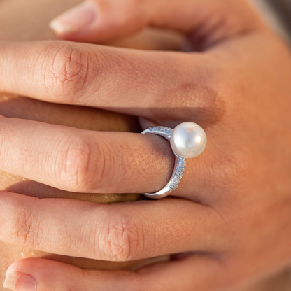 A person wears their stunning Stella Petite Pearl Ring featuring a Cygnet Bay (WA) grown Australian South Sea pearl complemented by 36 White Diamonds set in gold.