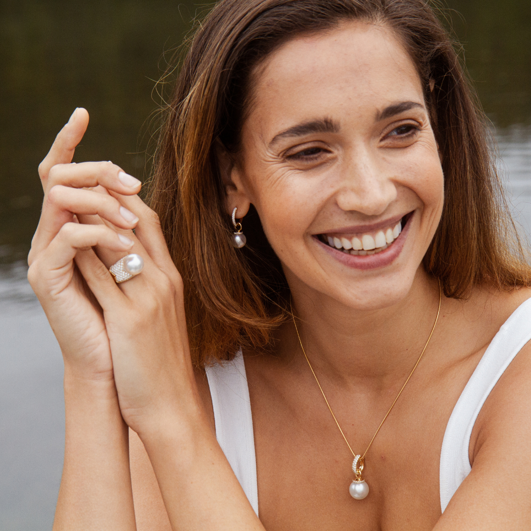 A woman wears her stunning Stella Pearl Ring featuring a Cygnet Bay (WA) grown Australian South Sea pearl complemented by 115 White Diamonds set in gold.