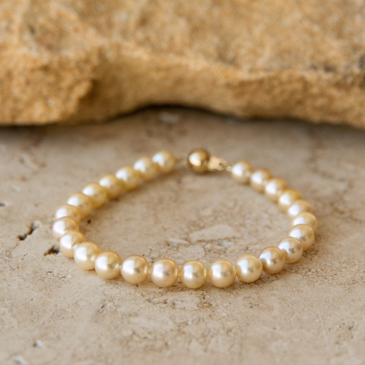 Pearl Strand bracelet on a textured stone surface