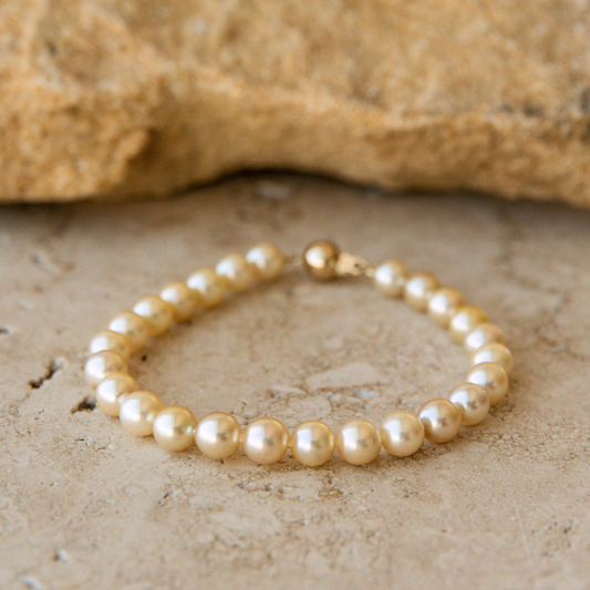 Pearl Strand bracelet on a textured stone surface