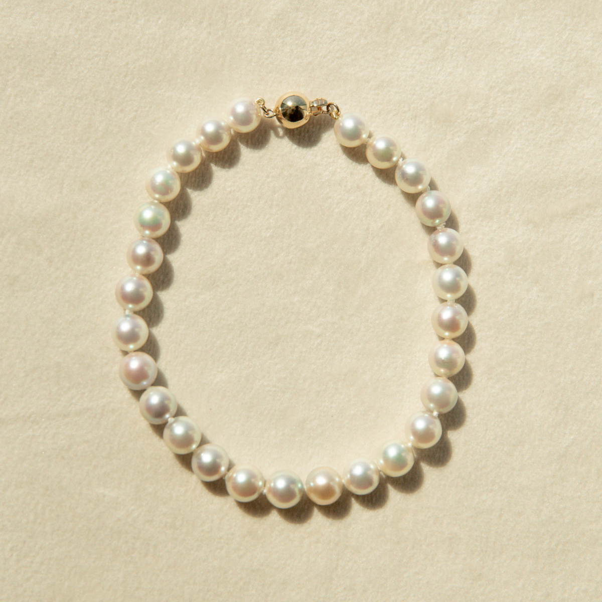 Pearl bracelet on a beige background