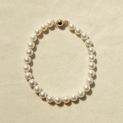 Pearl bracelet on a beige background