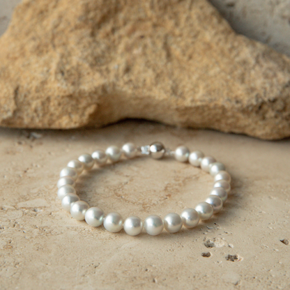 Pearl strand bracelet on a stone surface
