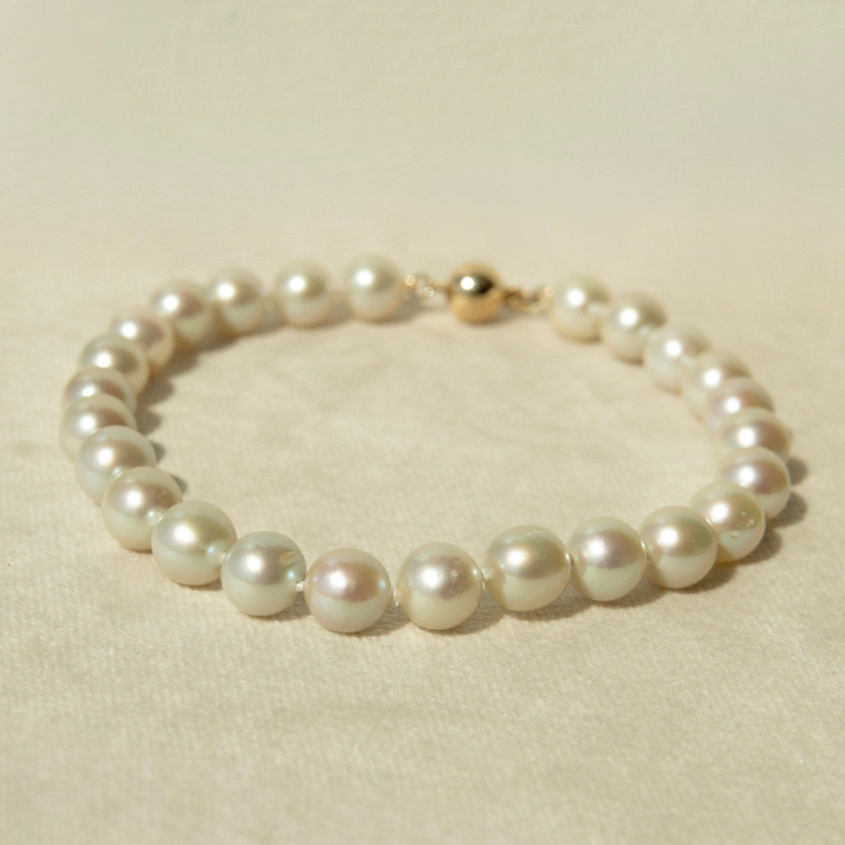 Pearl bracelet on a beige background