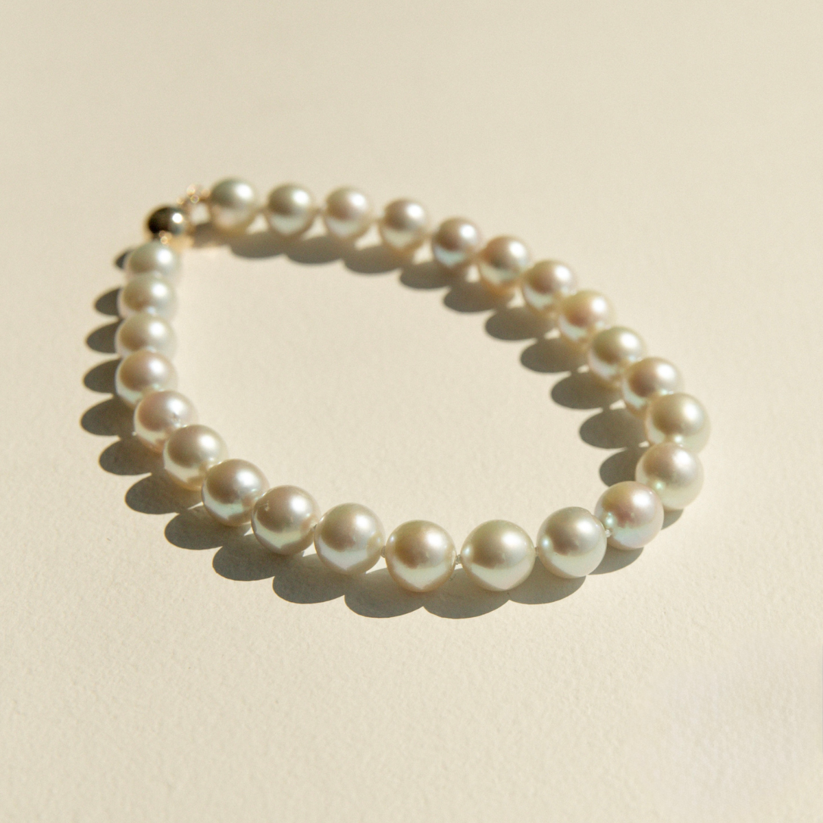 Pearl bracelet on a beige background