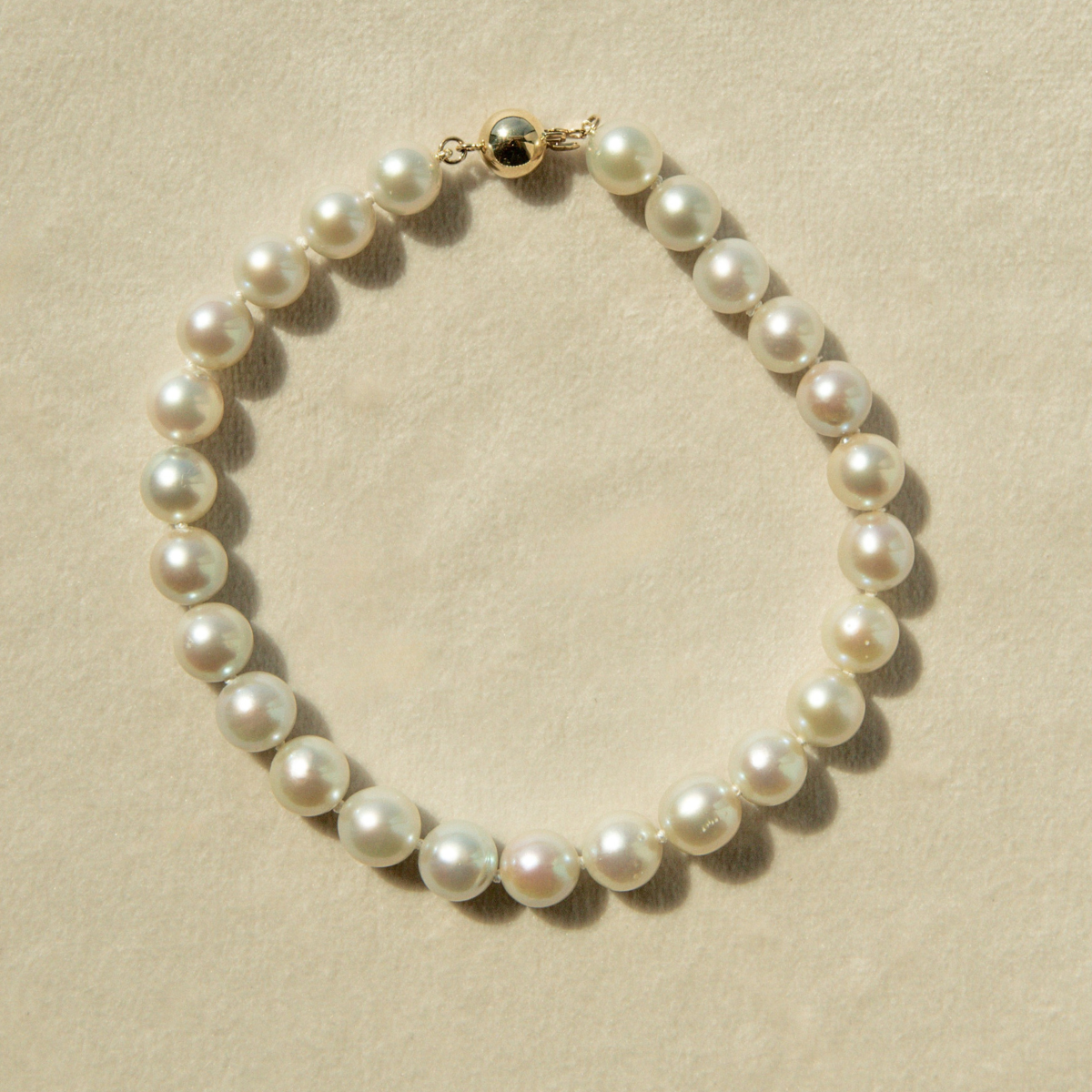 Pearl bracelet on a beige background